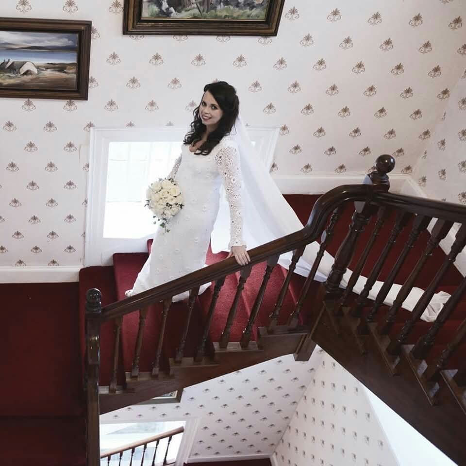 A white crochet wedding dress shown as a family keepsake