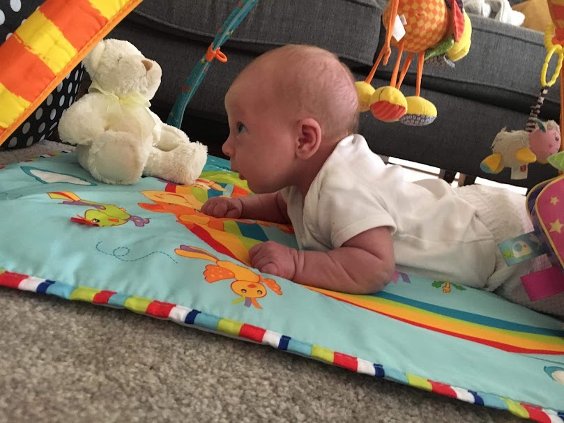 Baby taking part in tummy time during everyday play