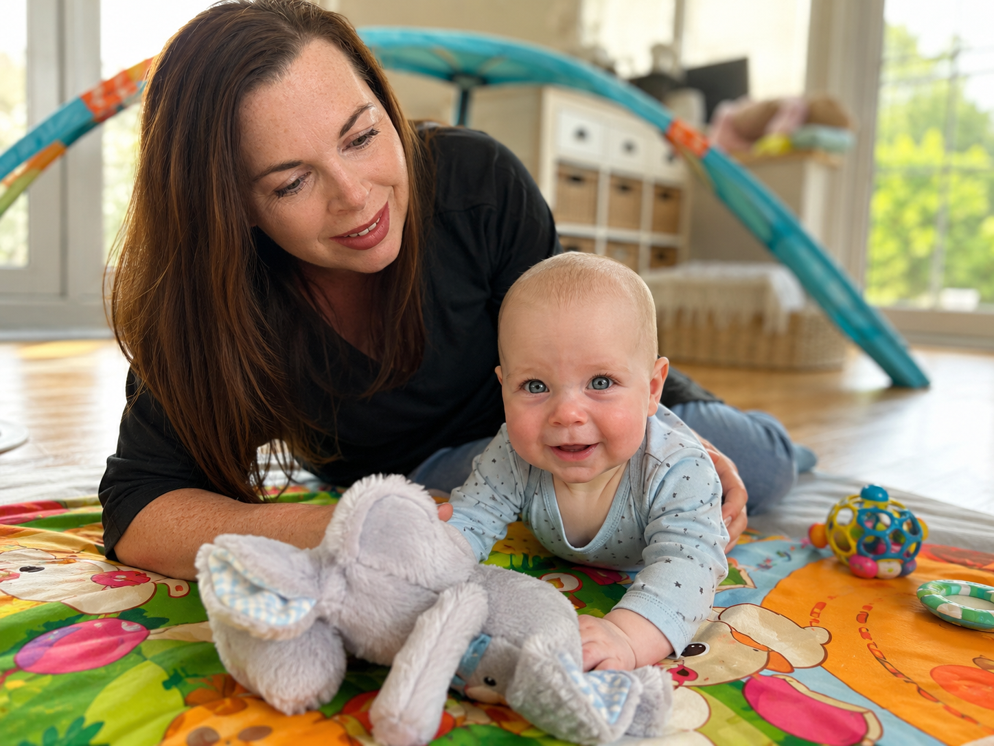 Parent and young child playing together on the floor in a calm home setting